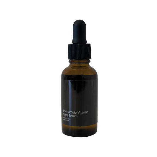 Amber glass dropper bottle of Even Ground Serum standing upright on a white background