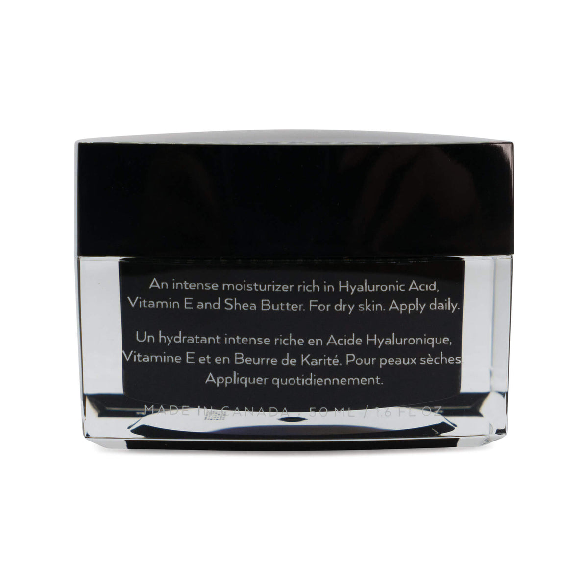 Closed black glass jar of The Barrier Balm showing ingredient label with hyaluronic acid, vitamin E, and shea butter